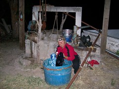 Nancy washing clothes by the well at the abandoned homestead